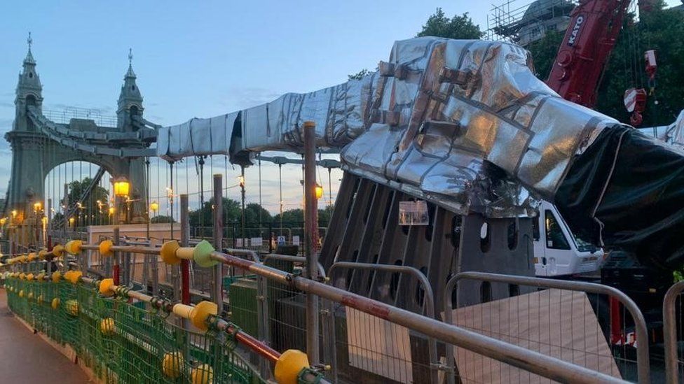 The Hammersmith Bridge is wrapped in foil to prepare for the European heat wave