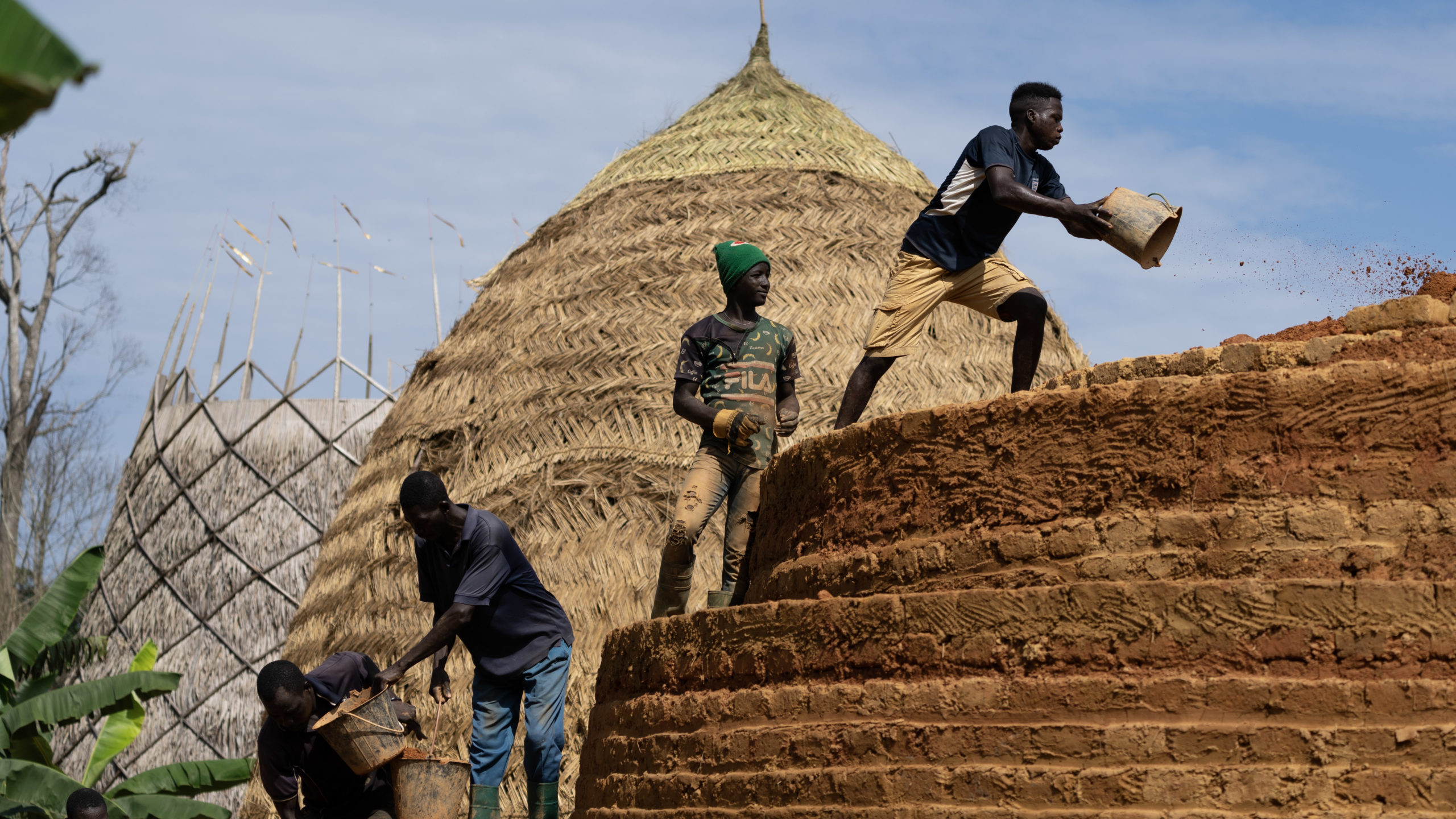 Crews work to build a Warka Tower, which captures condensation to provide clean water
