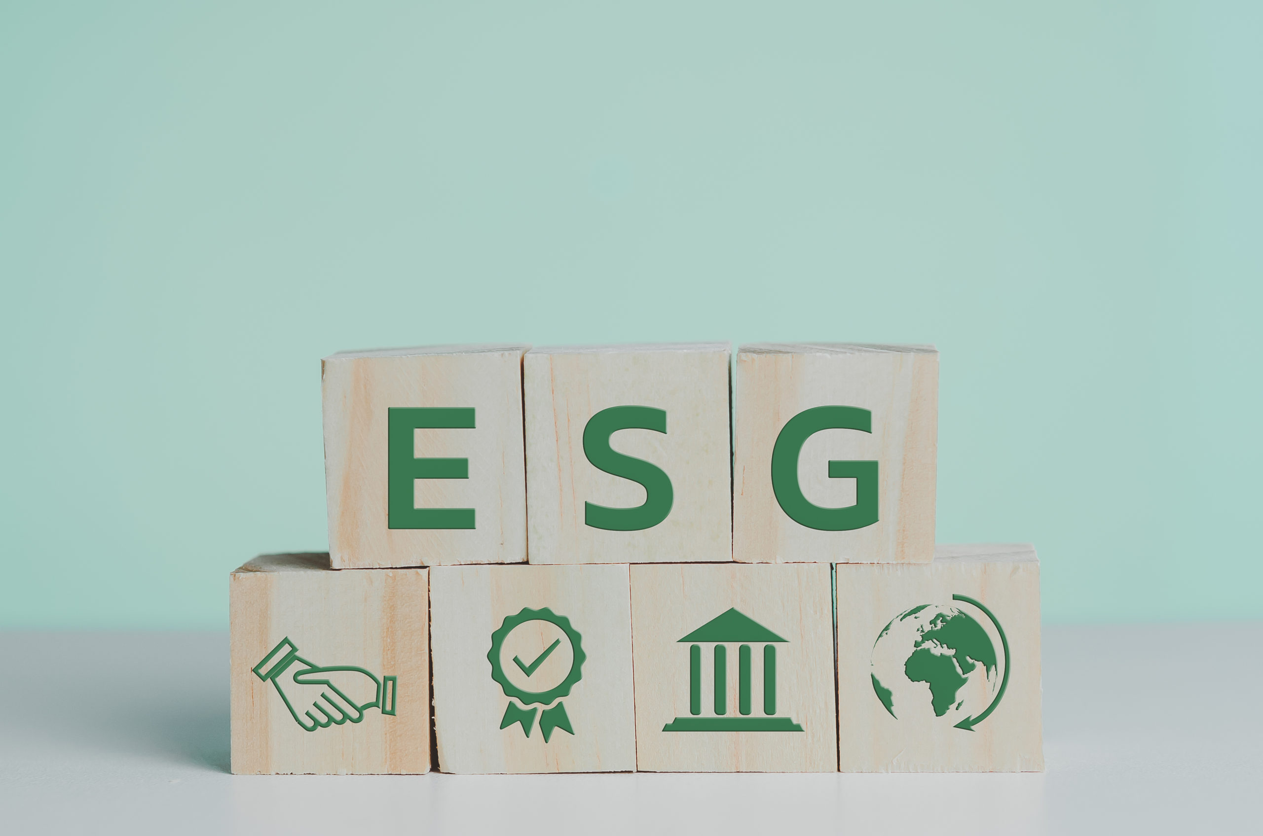 ESG: wooden cubes with ESG Environmental Social Governance symbol on table copy space