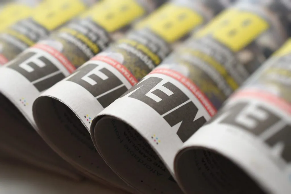 Rolled newspapers laying against each other.