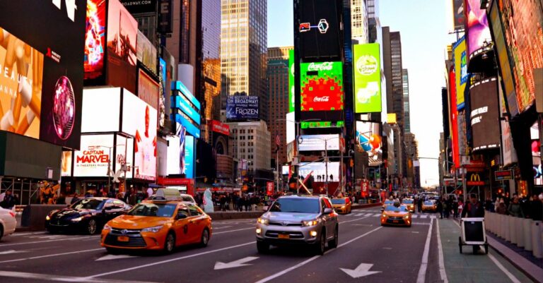 Times Square street scene with digital billboards, traffic and pedestrians, illustrating out-of-home advertising and media placement.