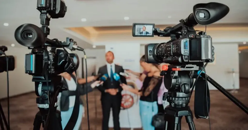 Startup founder speaks to reporters on camera during a media interview.
